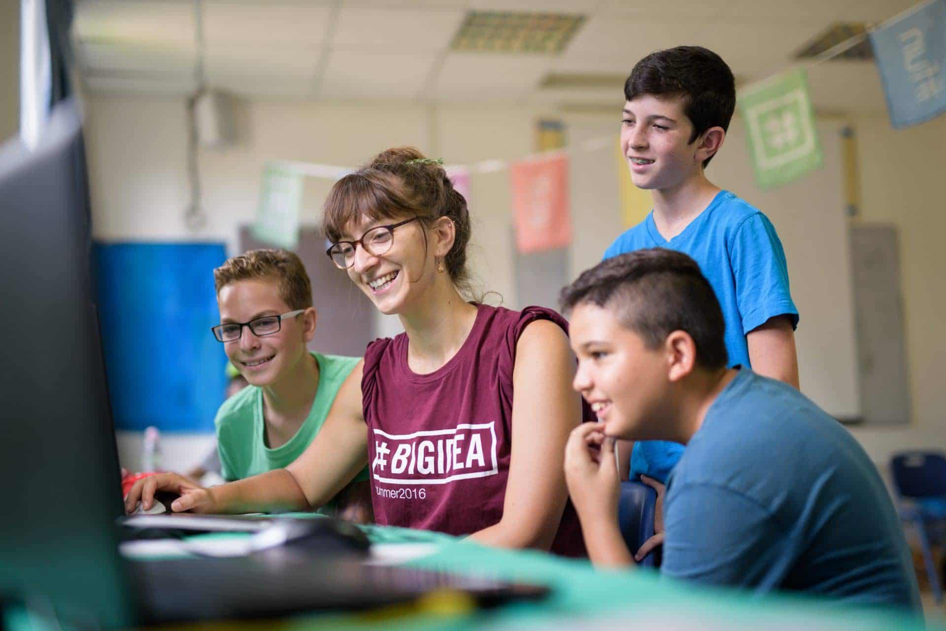 Big Idea Counselor with campers with computers